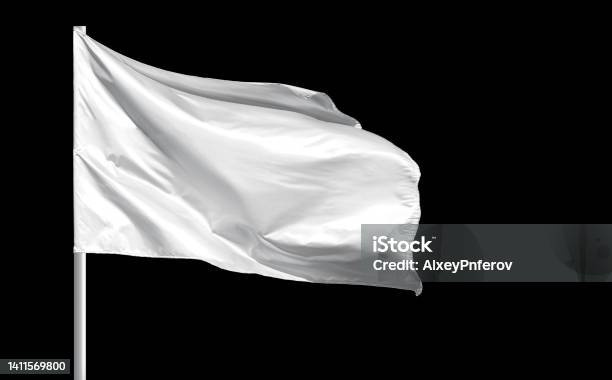 Fluttering Blank White Flag On Flagpole Isolated On Black Background Stock Photo - Download Image Now