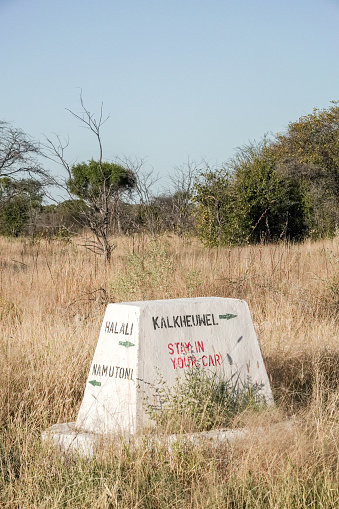 Stay in Your Car Road Warning Sign to Kalkheuwel (Afrikaans for 'limestone hill') Waterhole in Etosha National Park at Kunene Region, Namibia