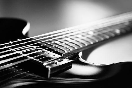 Extreme Close up shot of an electric guitar in Black and White - selective focus
