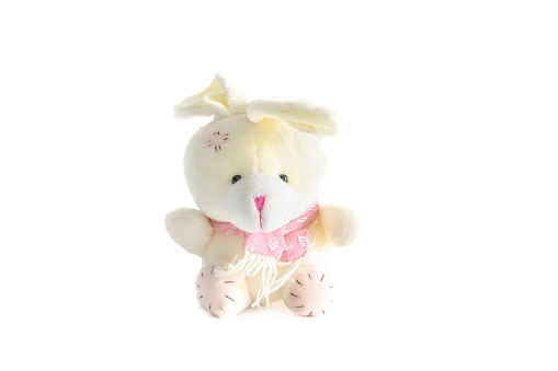 white fluffy bunny rabbit toy sitting on white background with copy space.