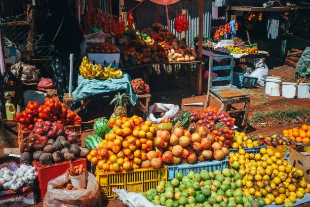 Photo of Fruit and vegetable market in Africa. Colorful healthy ingredients from the farm or from nature at the local market in Kenya. Bananas, mangoes, fruits and vegetables.