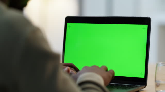 Closeup of laptop with a green screen copyspace. One unknown businessperson using technology in the office. Advertising, promoting and marketing for creative web design on chromakey computer monitor