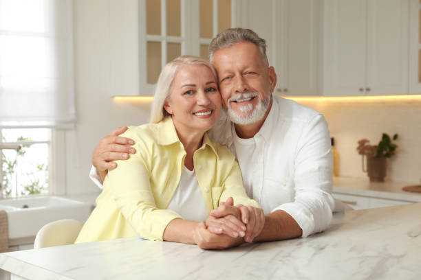 istock Happy senior couple at table in kitchen 1411574209