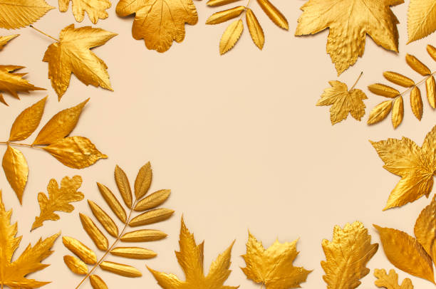 istock Flat lay creative autumn composition. Frame from Golden leaves on beige background top view copy space. Fall concept. Autumn background. Minimal concept idea, floral design 1411574800