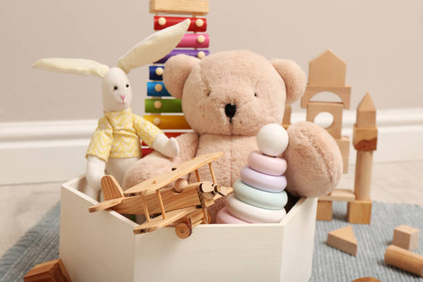 istock Set of different toys in box on floor, closeup 1411575655