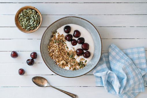 Curd cheese with granola, cherries and pumpkin seeds