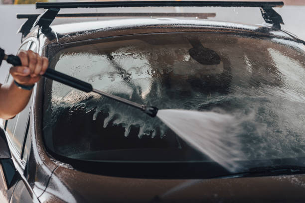 istock Young man washing car 1411577396