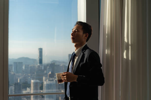 istock Business man drinking tea by the window 1411579071