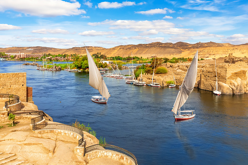 The Nile river scenery and traditional sailboats, Aswan, Egypt.