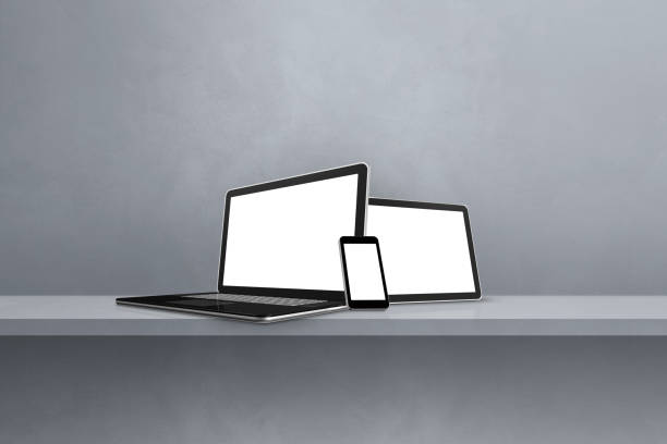 istock Laptop, mobile phone and digital tablet pc on grey wall shelf. Horizontal background 1411581738