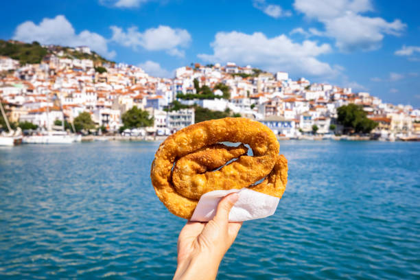 istock A female hand is holding a traditional, local cheese pie so called Tyropitta 1411583461