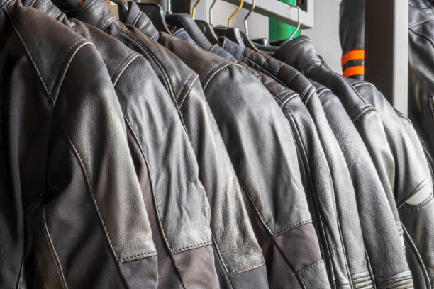 istock Black leather jackets for motorcyclists hang in a row close-up 1411589088