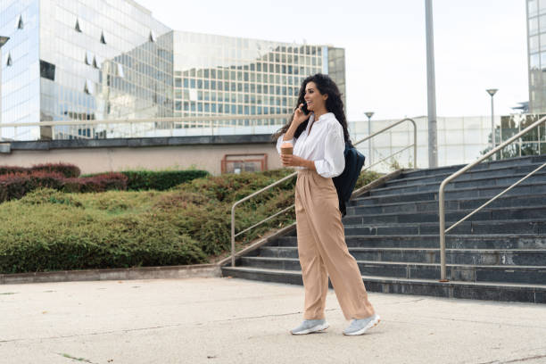 istock Young businesswoman talking on mobile phone after work 1411590723
