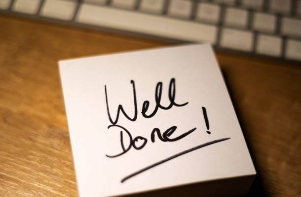 Well Done, text note. Office desk with notepad and keyboard in the background. In black the handwritten text, well done. Achivement, inspiration and motivation. educational test results stock pictures, royalty-free photos & images