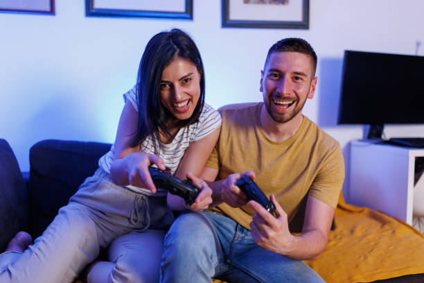 istock Joyful roommates playing video games at home 1411594069