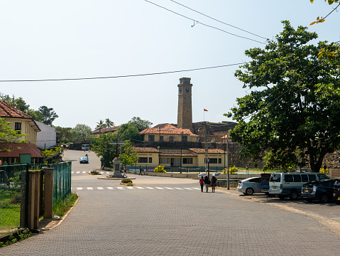 Galle, Sri Lanka - March 12, 2022: View of the Dutch-built Galle Fort and the old large clock tower built in 1883. Pointer with landmarks at a crossroads in the city of Galle.