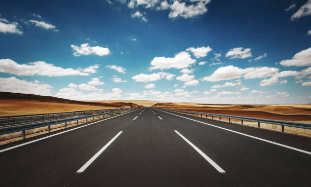 Empty highway road in a cloudy summer day stock photo