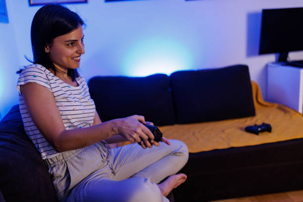 istock Excited female gamer at home 1411595772