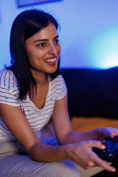 istock Woman playing a video game at home 1411595861