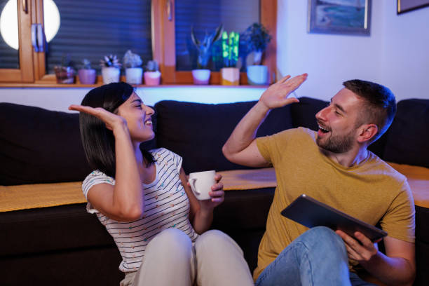 istock Young couple playing games on digital tablet 1411595988