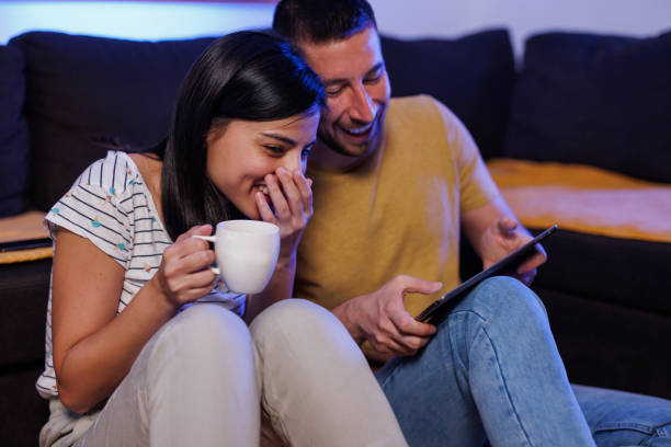 istock Young couple playing games on digital tablet 1411596021