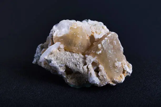 Honey calcite in crystal and needle form. Honey Calcite also known as Golden or Amber Calcite is a calcium carbonate mineral that occurs in masses and rhombohedral forms