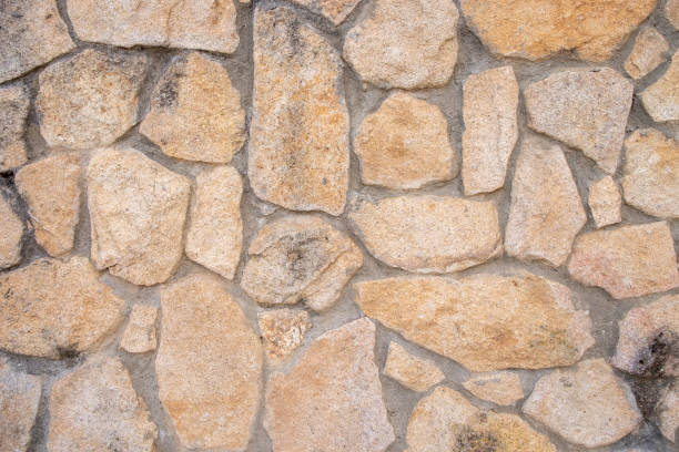 istock Wall built with granite stones and joined with cement. 1411596626