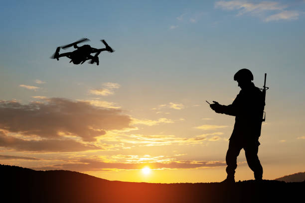 istock Silhouette of soldier are using drone and laptop computer for scouting during military operation. 1411604195