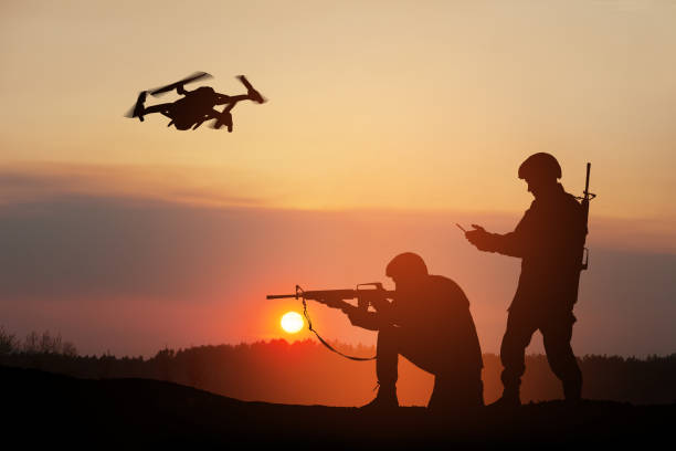 istock Silhouettes of soldiers are using drone and laptop computer for scouting during military operation. 1411604272
