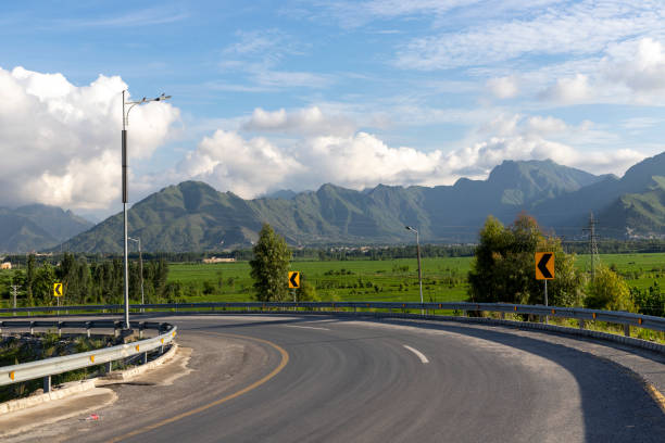 istock Highway bends to the left with a beautiful view 1411604465