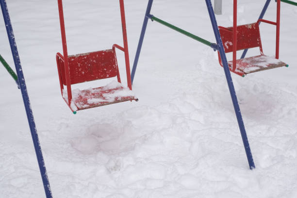 istock Swing seat covered with snow, winter season 1411604567