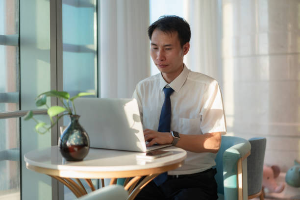 istock Asian business man is working with laptop 1411604697