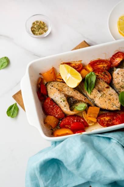 istock Roasted salmon steak with vegetables in baking dish food 1411604874