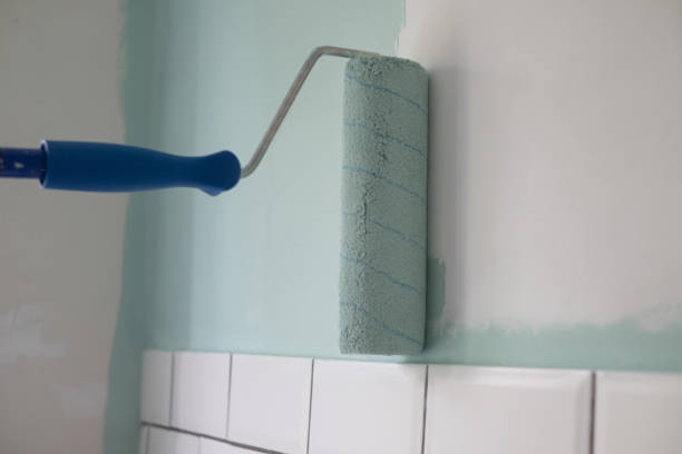 istock Paint rolle painting on surface wall. Renovation in house 1411606009