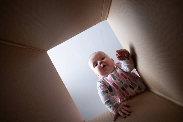 istock Happy baby into parcel cardboard box and smiling. 1411606032
