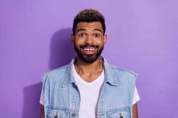 photo of funny attractive man wear jeans waistcoat smiling isolated violet color background - toothless grin imagens e fotografias de stock