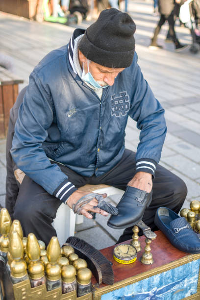 Shoeshiner Istanbul Turkey; December 05, 2021: Man polishing shoe, Uskudar Square Istanbul Turkey shoe polish photos stock pictures, royalty-free photos & images