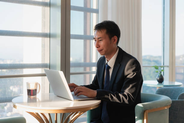 istock Asian business man is working with laptop 1411609299