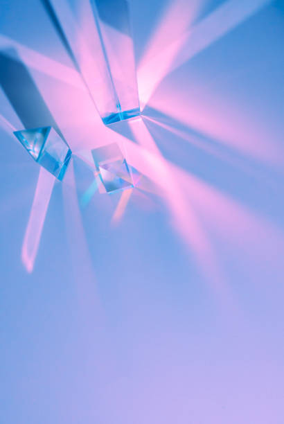 istock Glass prisms and cubes with color spectrum rays. Abstract background with reflection and refraction of light. Shadow and rays of natural light effects. 1411611575