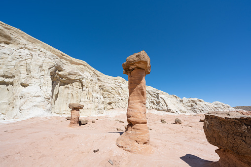 Toadstool Hoodoos in the heat of the desert near the city of Kanab in Utah, USA. Seen a hot summer day with blue sky in the background.