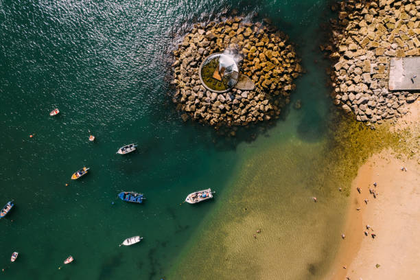 Top down aerial biew of people at Praia Velha which means Old Beach at Paco de Arcos bay in Oerias, Lisbon Region, Portugal stock photo