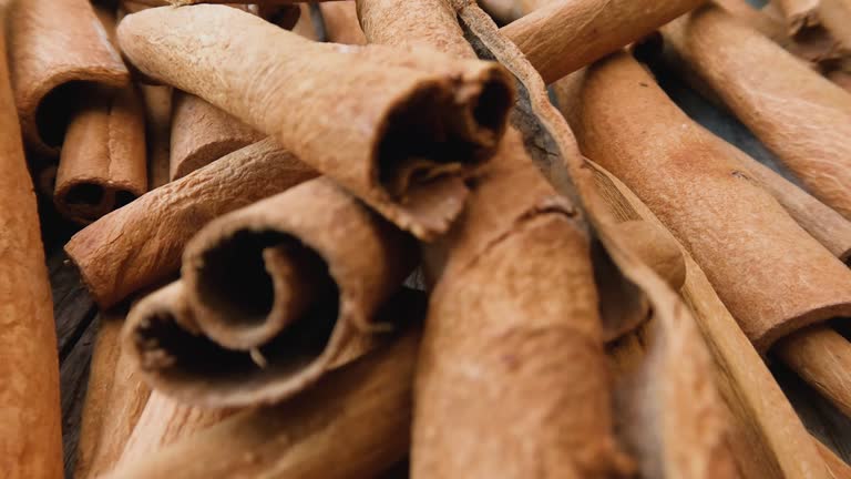 Cinnamon spice stick background, with the cinnamon on an old weathered teak wood board.