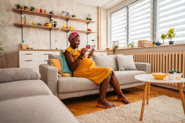 istock Young Pregnant Woman Shopping Online Using Tablet 1411616204