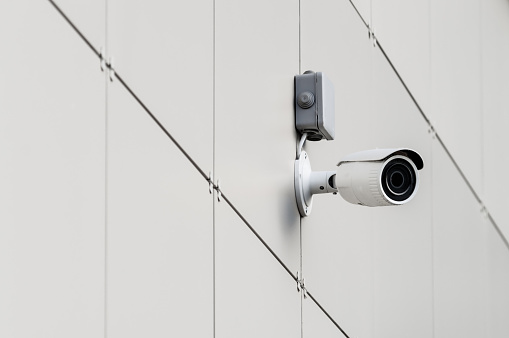 CCTV camera on the wall of a modern building. Selective focus