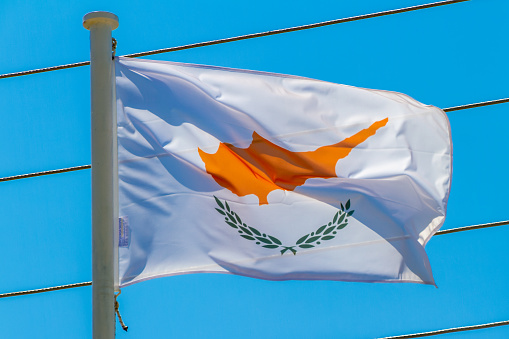 Kalamata, Greece, July 21, 2022. Flag of Cyprus. This flag depicts the map of the island placed above two olive branches on a white background.