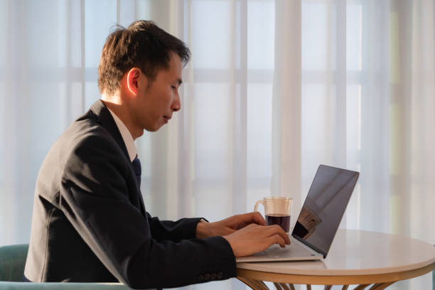 istock Asian business man is working with laptop 1411618465