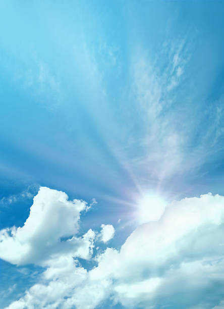 Fluffy clouds with sun on the sky, soft focus. Heavenly clouds background in summer day. Concept of freedom, relaxation, ecology. Copy space. Empty place for message.