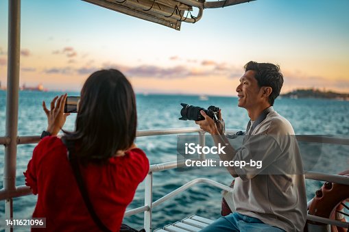 istock Young couple tourists taking ferry tour during their travel 1411621096