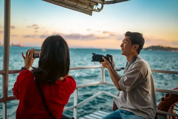 Photo of Young couple tourists taking ferry tour during their travel