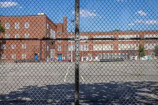 Public school number 112 Dutch Kills behind a fence  in Long Island City which is a part of Queens and is a mixture of new and old, small industries and residential areas close to Manhattan, New York